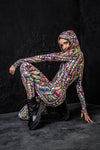 Model is crouched showing off a different side of the hippie knot Rave Onesie 